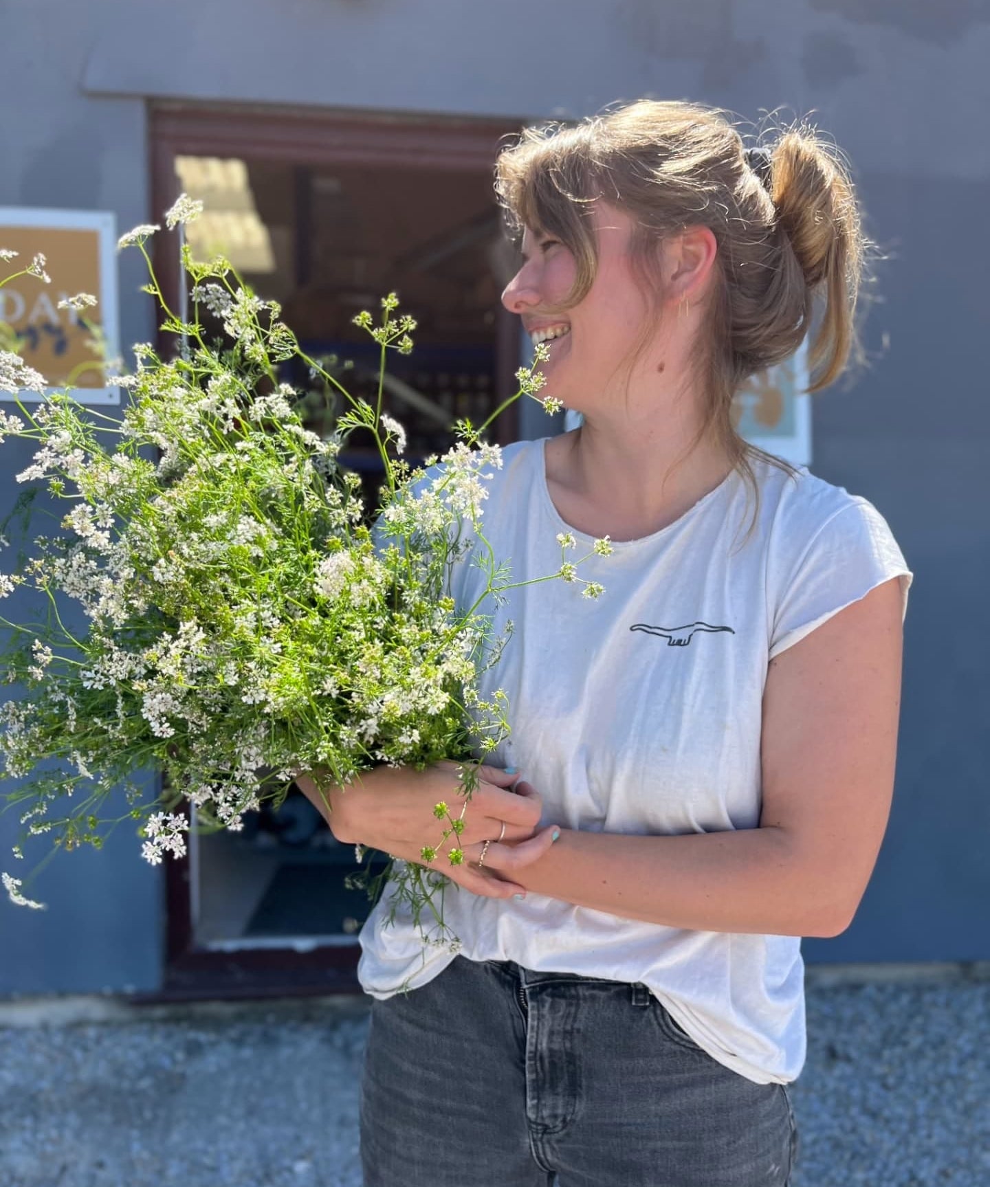 Woman holding a bouquet of fresh herbs