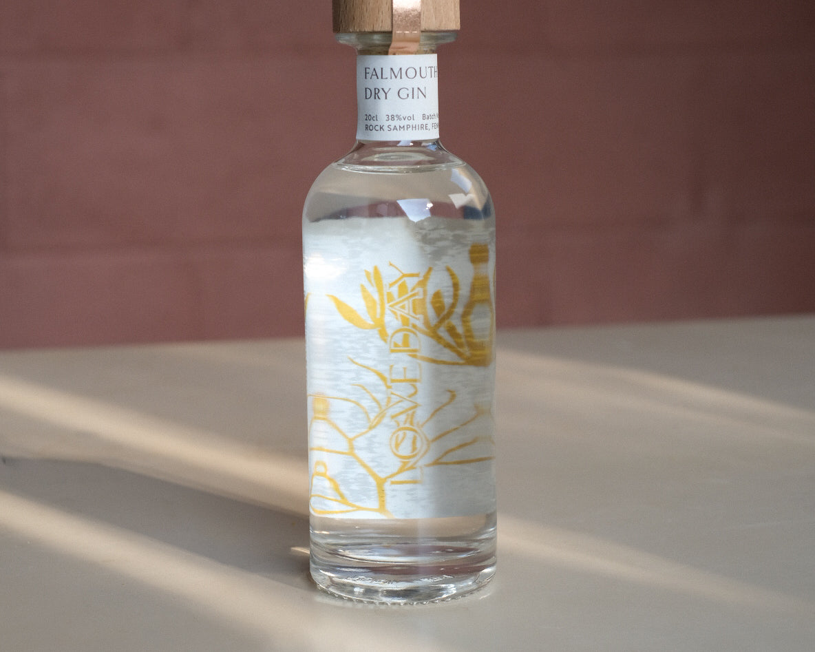 Falmouth Dry Gin 20cl bottle by Loveday Distillery with golden botanical label and wooden cap, shot in warm natural light
