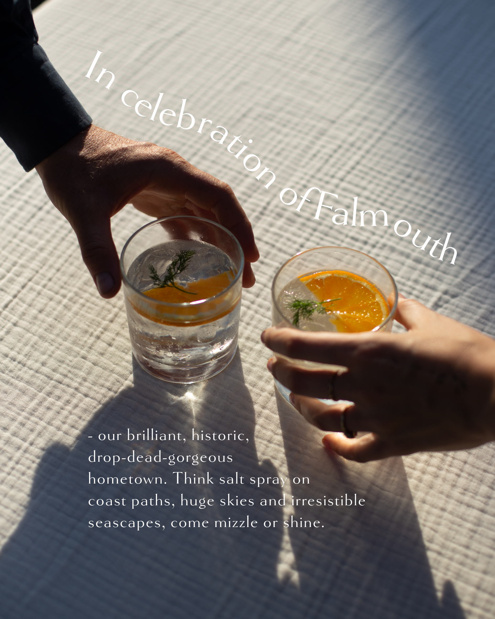 Two hands reaching for gin and tonic glasses with orange slices and dill, celebrating Falmouth Cornwall