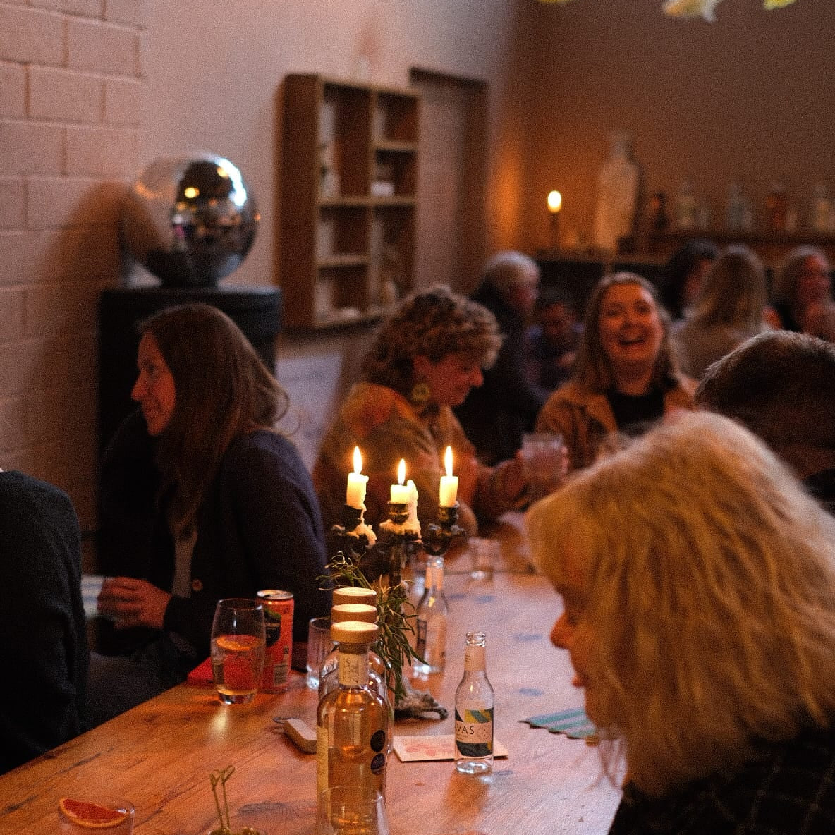 People drinking cocktails in a distillery taproom